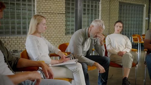 Adults in Support Group Expressing Sadness