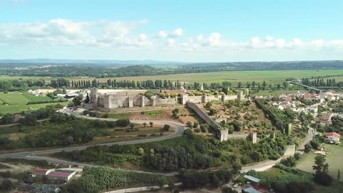 Circling around a historical castle on top of a hill in a small city.
