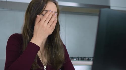 Late Night Work Causing Stress and Exhaustion for Businesswoman in Home Office Resulting in