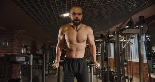 Muscular Man Doing Dips at the Gym