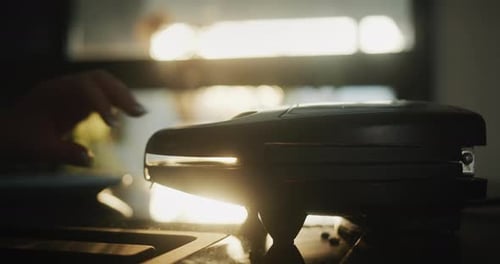 Placing Sandwiches in Sandwich Press at Sunrise