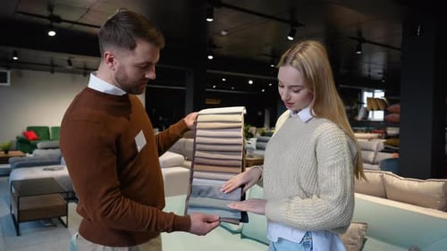 Woman and Man Choosing Fabric Samples in Showroom