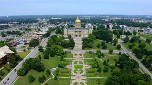 Des moines Iowa state capitol building aerial flyby during a sunny midwestern day