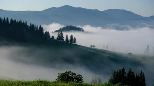 Misty Mountain Peaks Rising Above Thick Clouds At Early Sunrise