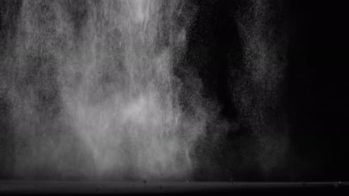 Sahara Collection: Large amount of sand falling continuously from the top over a black background sh