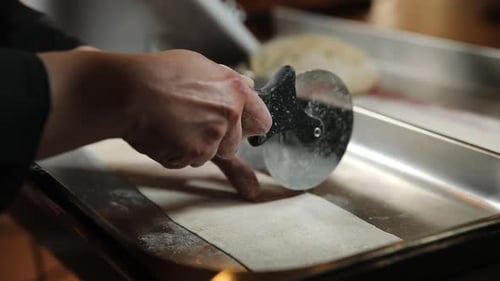Step by step the chef prepares ravioli. The chef works with the dough