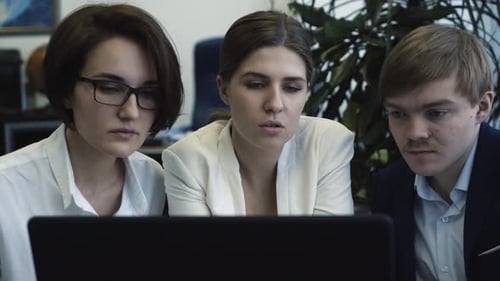 Business Team Analyzing Data on Laptop in Office Meeting