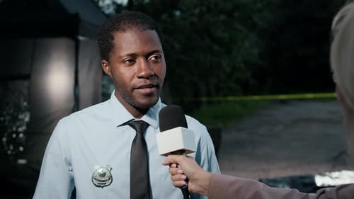 Journalist Interviewing Police Officer at Night Crime Scene