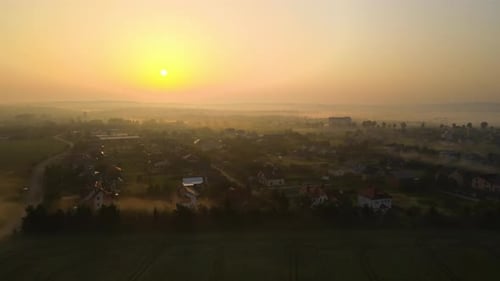 Aerial View Foggy Sunrise Over Residential Houses in Suburban Rural Area