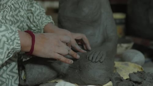 Sculptor Working With Clay to Create Art