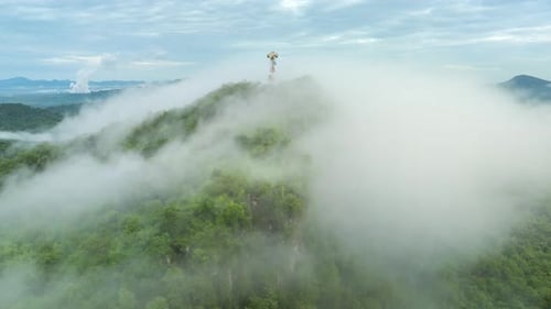 4K Hyperlapse of Mountain Peaks Covered in Fog with Signal Station Above
