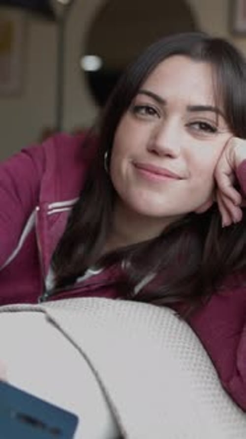 Thoughtful Young Woman Thinking While Looking Away in the Living Room