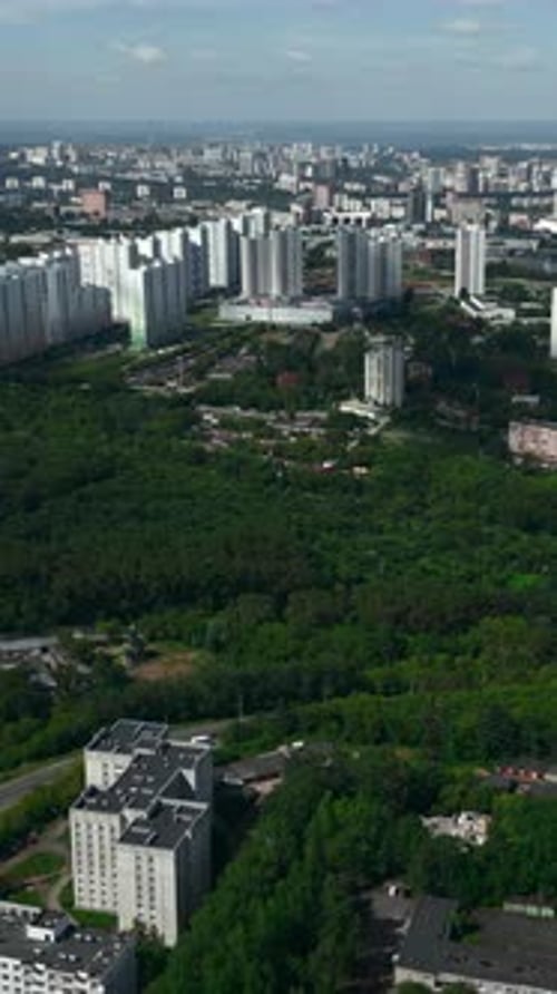 Aerial View Flying Over Residential Buildings and Green Forest Park Clip