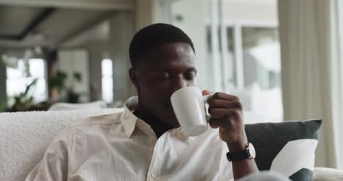 Drinking, coffee and man on break, house and warm beverage on weekend, remember and relax in lounge