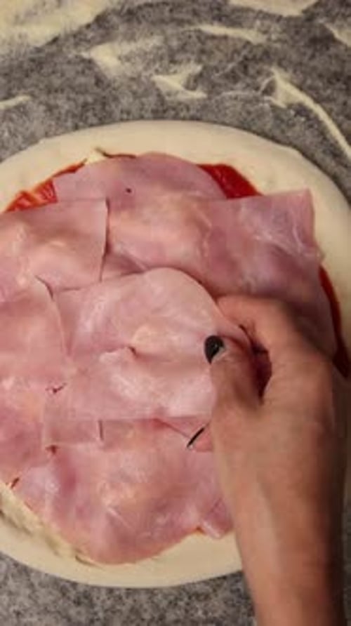 The chef makes delicious pizza in a professional kitchen.