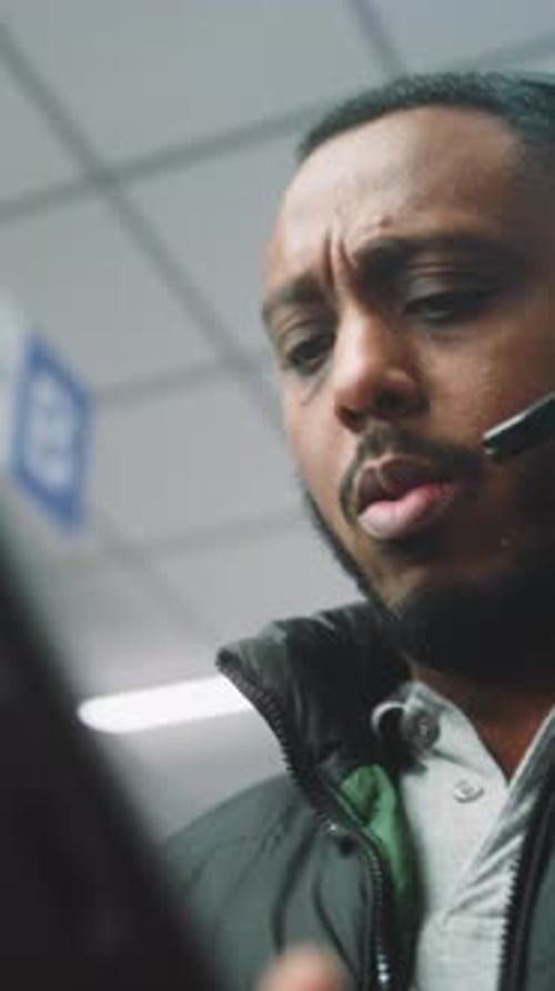 Young Adult With Headset Looking at Screen