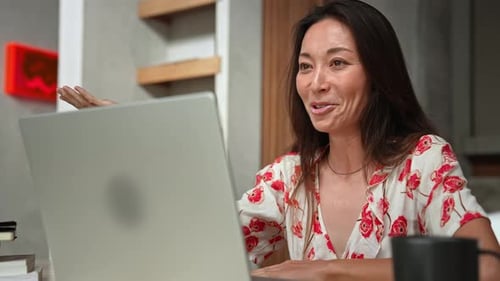 Woman Works Talking at Video Call on Screen of Laptop Computer in Home Office