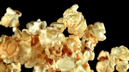 Delicious Caramel Popcorn Floating on Black Background