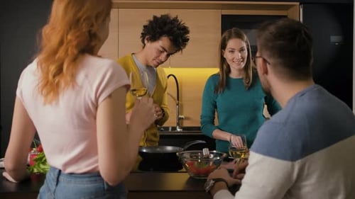 Four Young Adults Cooking Together at Home