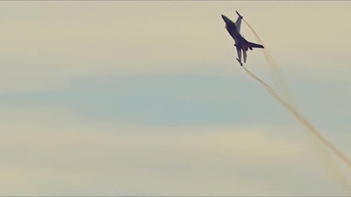 Fighter Jet Flying Leaving Smoke Trail in Sky