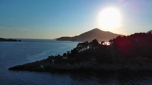 Scenic Coastal Sunset with Island Silhouette Aerial View