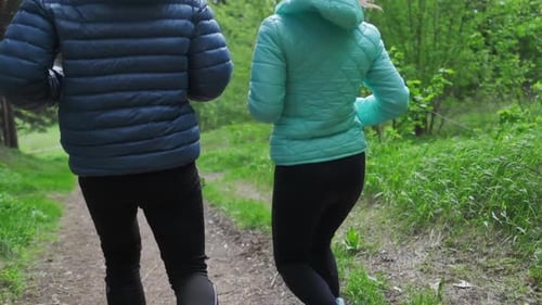 Sportive young people running. Couple run in the park during the day