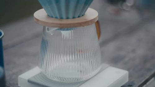 Pouring Coffee Grounds Into Pour Over Coffee Maker