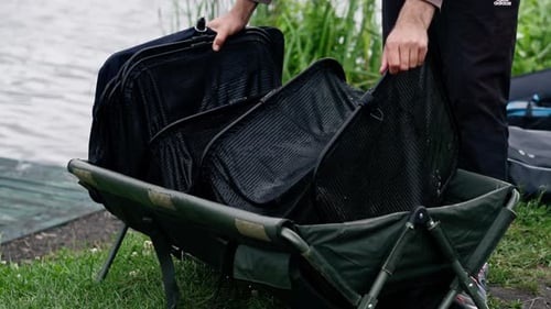 a fisherman holding a full professional net for catching fish on the river