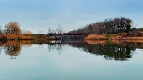 Zwei trockene Flussufer, die durch die Metallbrücke miteinander verbunden sind.
