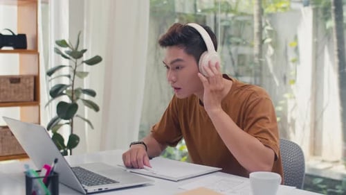 Young Adult Video Calling at Desk Indoors