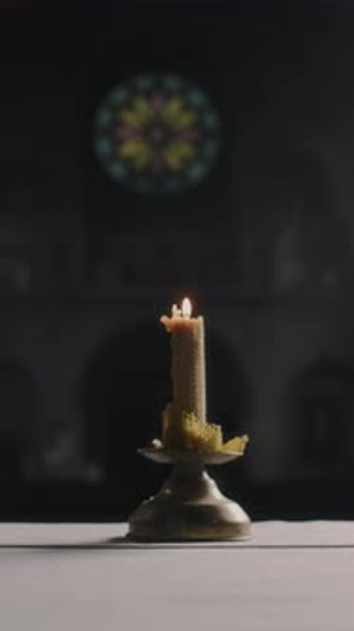 Burning Candle on Altar in Gothic Cathedral