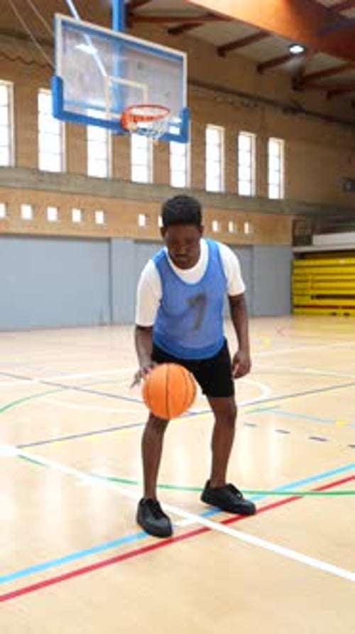 Young Basketball Player Dribbling and Posing on Court