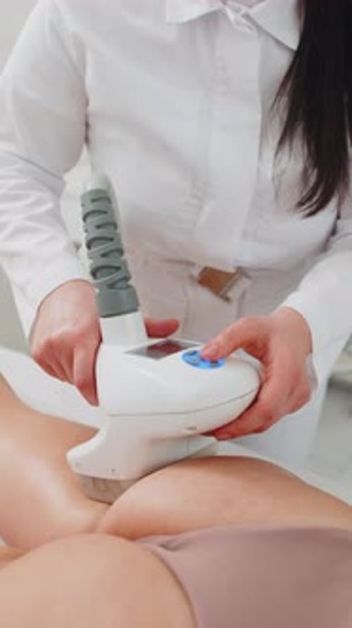 Anticellulite Massage Cosmetologist Makes a Woman Cavitation Vacuum RF Lifting Spa Legs Procedure