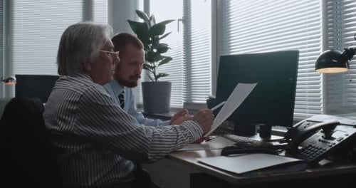 Corporate Business Partners Monitor Equity Market and Shares on Computer Discuss Strategy