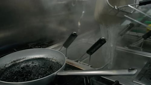 Chef Making Black Pasta Spaghetti At Squid Ink In Italian Restaurant