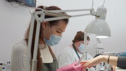 Woman Doing Manicure at Nail Salon During Daytime