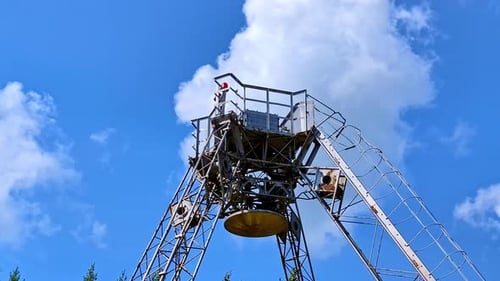 Static shot of radio RT-32 telescope metallic structure under sunny blue skyline