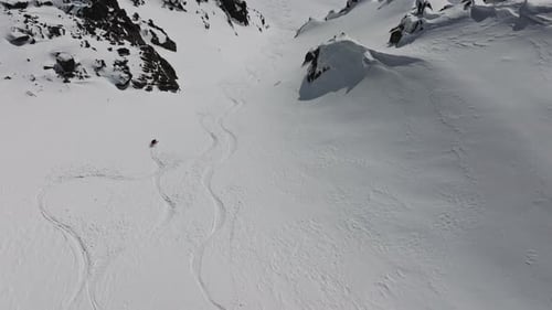 Skier Leaving Tracks on Fresh Snow in Mountain Valley