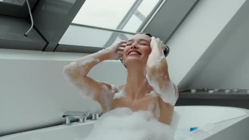 Woman Relaxing in Luxurious Bathtub with Bubbles