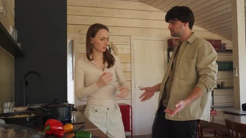 Couple Arguing Vigorously in Bright Kitchen