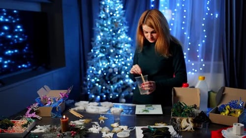 Woman Crafting Festive Decorations at Home During Christmas
