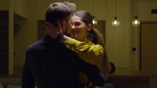 Couple Kissing and Embracing Affectionately Indoors