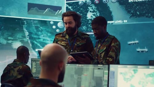 Men in Camouflage Reviewing Data in Command Center
