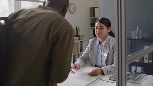 Woman Accepts Documents at Modern Office Desk