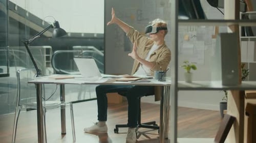 Young Architect Wearing VR Headset During Work with New Project at Bright Office