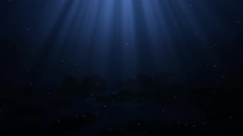 Underwater dark blue background with bubbles and sunbeam light rays on the deep ocean bottom