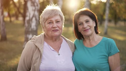 Senior Women Smiling During Golden Hour in Park