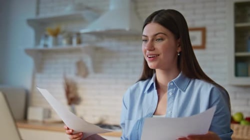Joyful Employee Checking Papers in Home Office Closeup Manager Looking Laptop