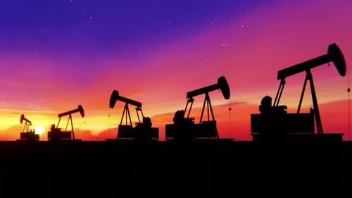 Oil Pumpjacks Pumping against Sunset Sky