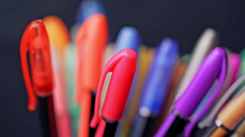 Close Up of Many Colorful Pens on Black